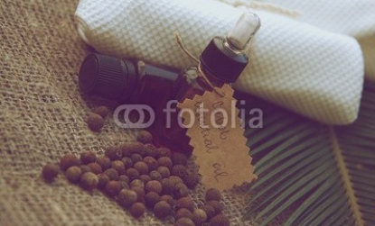 A_bottle_of_cubeb_essential_oil_on_the_sackcloth._Vintage.jpg